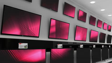 interior of electronics store with synchronized video playing on screens of multiple televisions