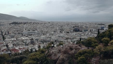 panoramic view of city surrounded by incredible historic breathtaking constructions in athens, greece - aerial orbit