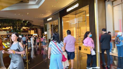 people exploring a bustling bangkok shopping mall