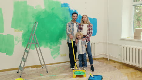 happy family posing in newly painted room