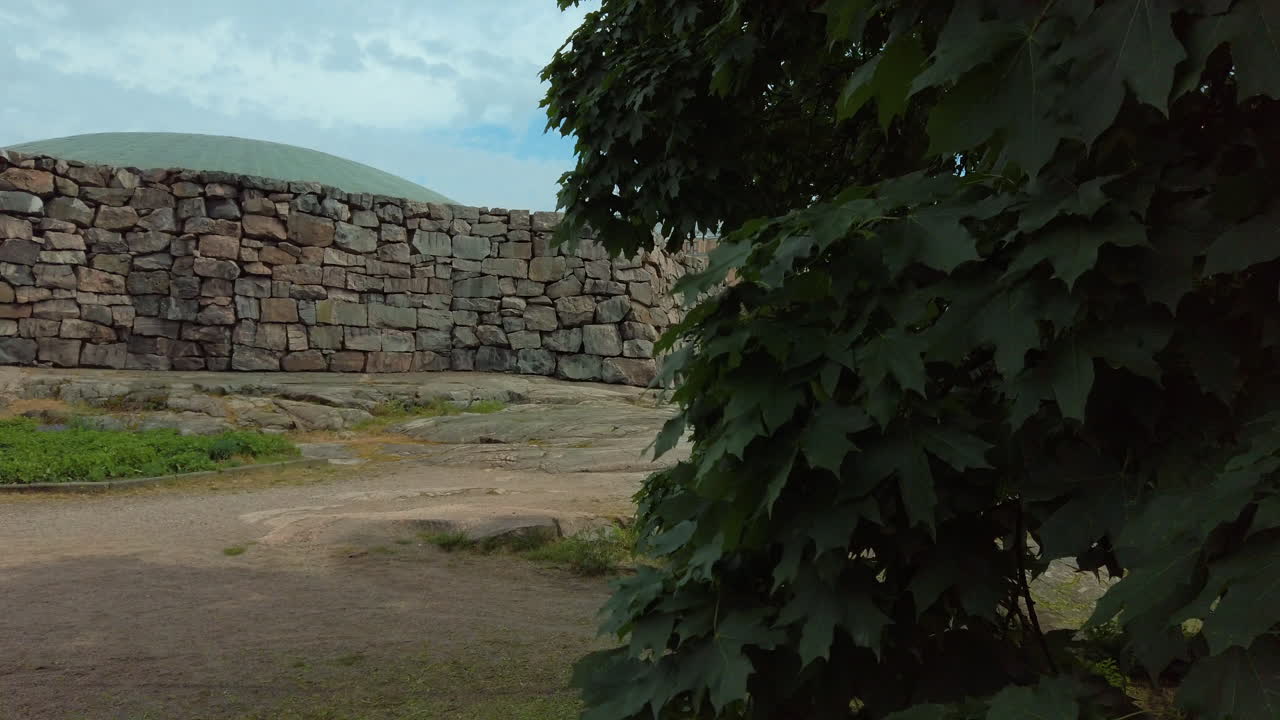 Parallax reveal of Temppeliaukio Church under a blue sky with clouds, Helsinki tourism