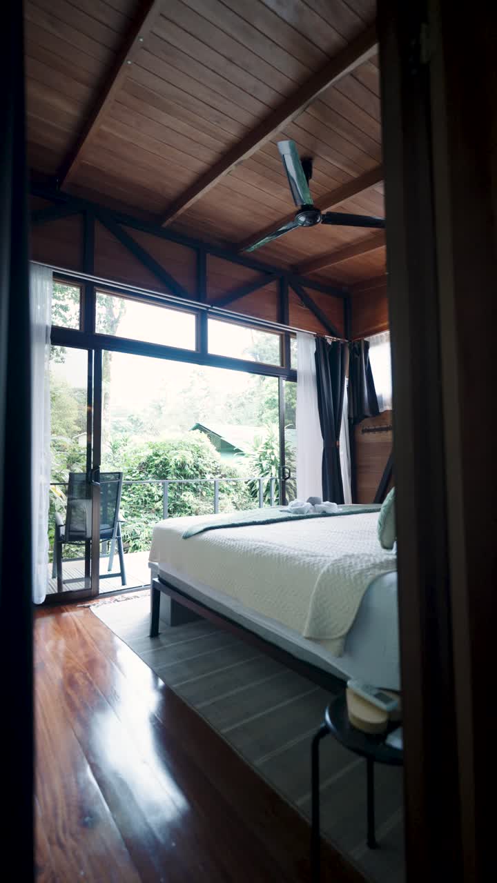 A bedroom with a view of nature