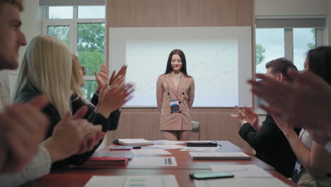 woman-speaker-of-business-conference-is-welcoming-participants-people-are-applauding