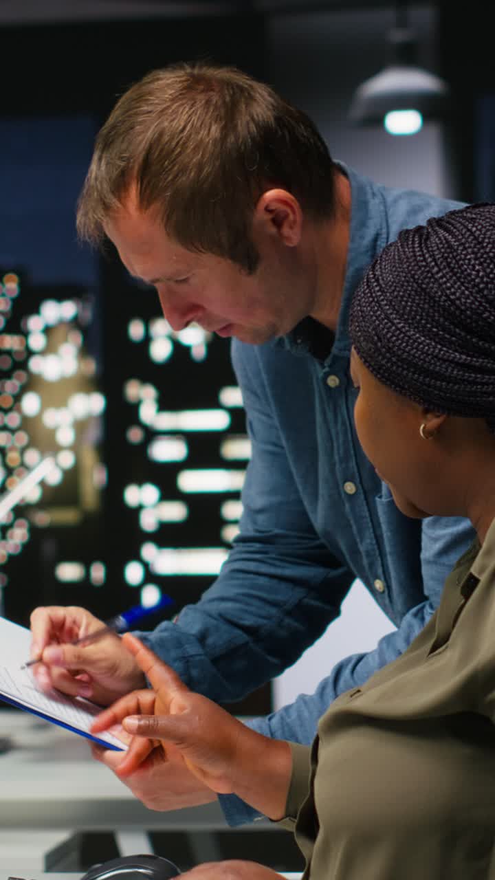 Vertical Video Team of multiethnic videographers editing video shoot in post production