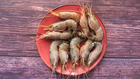 fresh prawns on a red plate