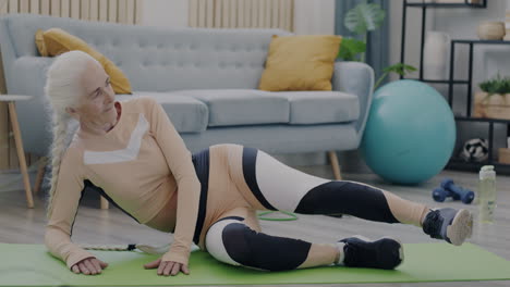 senior woman doing leg exercise at home