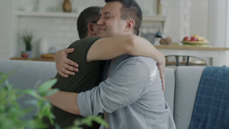 two men hugging on a sofa