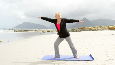front view of old caucasian woman exercising at beach 4k