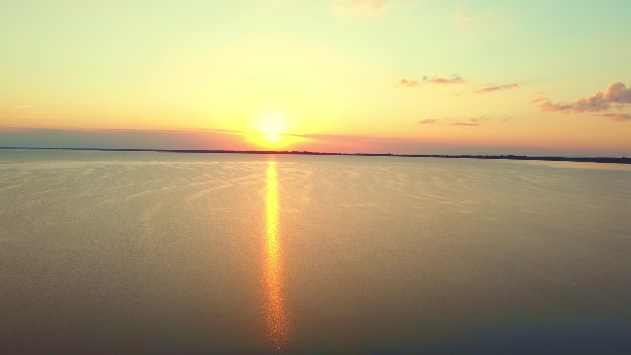 Sunset, at the sea with shoreline, seeing from the sky.