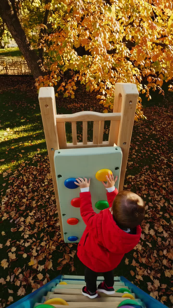 Toddler Climbing Playground Wall in Autumn