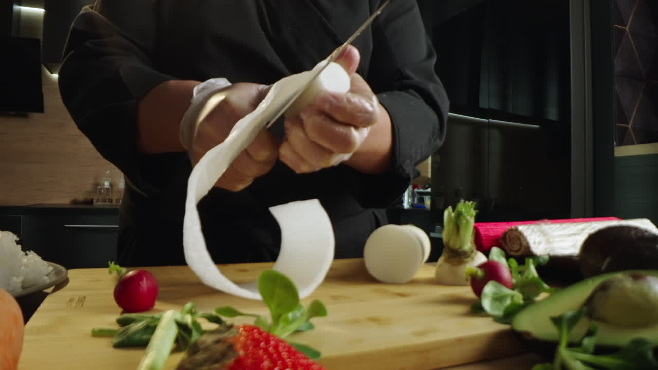 Chef peeling daikon radish in a kitchen