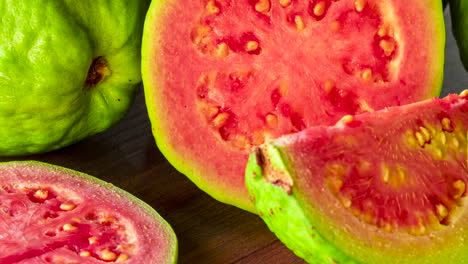 closeup-on-sliced-red-guavas-on-wooden-background