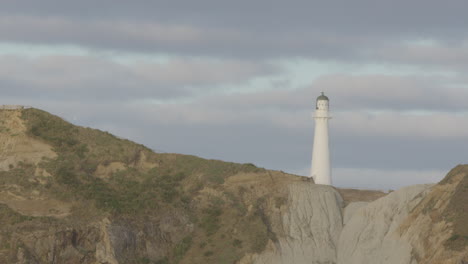 close-up of new zealand's rock formation and lighthouse at castle point