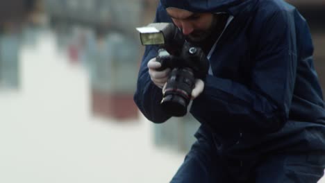 forensic expert photographing murdered person, front view closeup