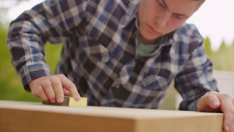 man sanding wood