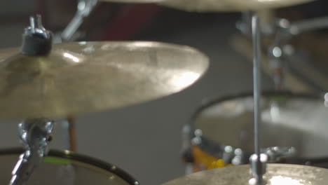 close up of cymbal on drum kit being hit in slow motion