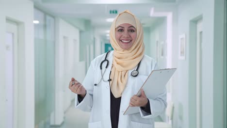 happy muslim doctor talking to patient