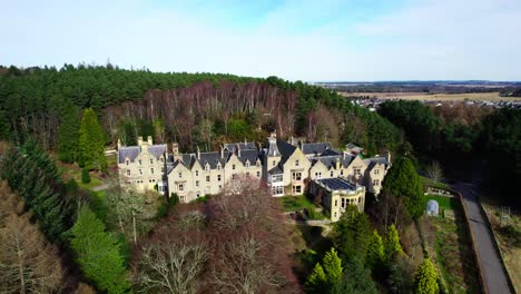 stunning aerial of findhorn foundation cluny hill castle, zoom out reveal