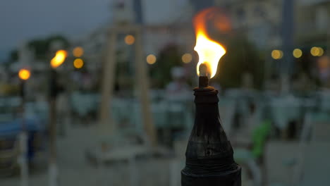 burning tiki torch at twilight