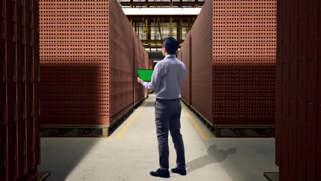 businessman inspecting brick inventory in a warehouse