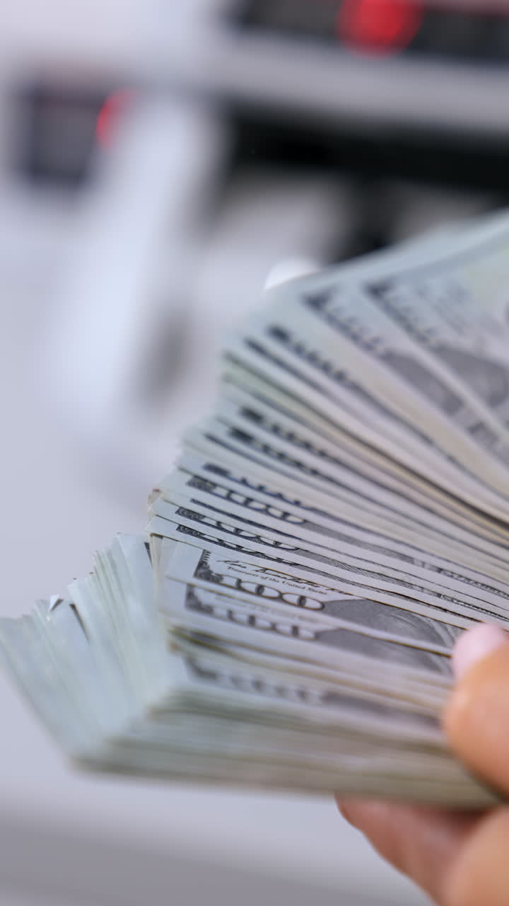 Female hands counting US Dollar bills. US national paper currency. Vertical video