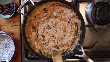 overhead timelapse of cooking italian dish in frying pan