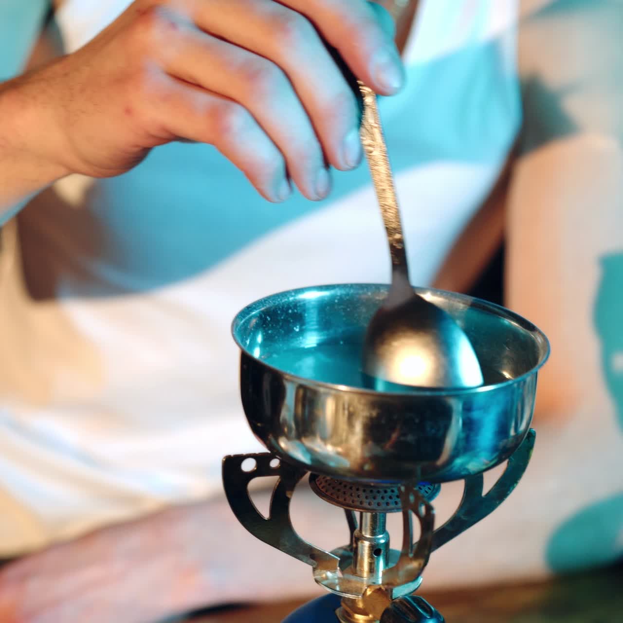 Hands of a drug addict melting cocaine. Drugs and the concept of crime.