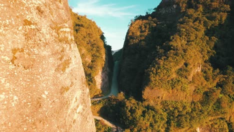 cinematic aerial view of one of the most legendary and dangerous roads in the world and the massive rock wall on both sides at sunrise, serra do corvo branco, urubici, santa catarina, brazil