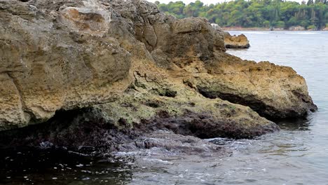 Calm-waves-hiting-rocks-on-a-gloomy-day-in-slow-motion