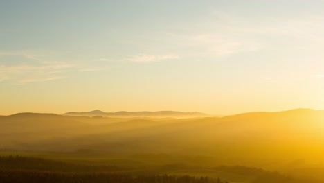 Time-lapse-of-Snezka,-Karkonosze-mountains,-during-a-foggy-yellow-sunset