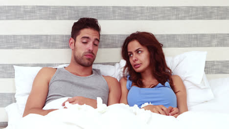 sick couple blowing nose