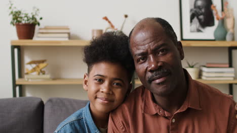 Old-man-and-boy-hugging-in-the-living-room