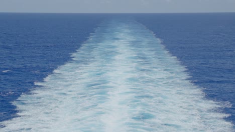 slow motion shot of vast caribbean ocean and trails from cruiseliner