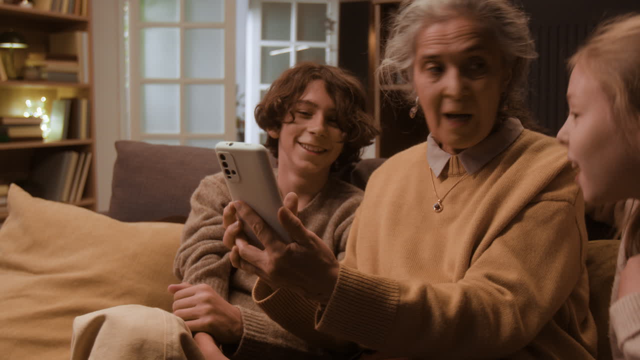 Grandmother and Grandchildren Video Calling on Phone