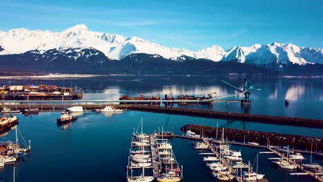 4K-Drone-Video-of-Seward-Boat-Harbor-and-Surrounding-Snow-Covered-Mountains-on-Snowy-Winter-Day-in-Alaska