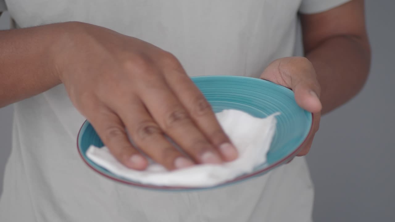 Cleaning a plate with a paper towel