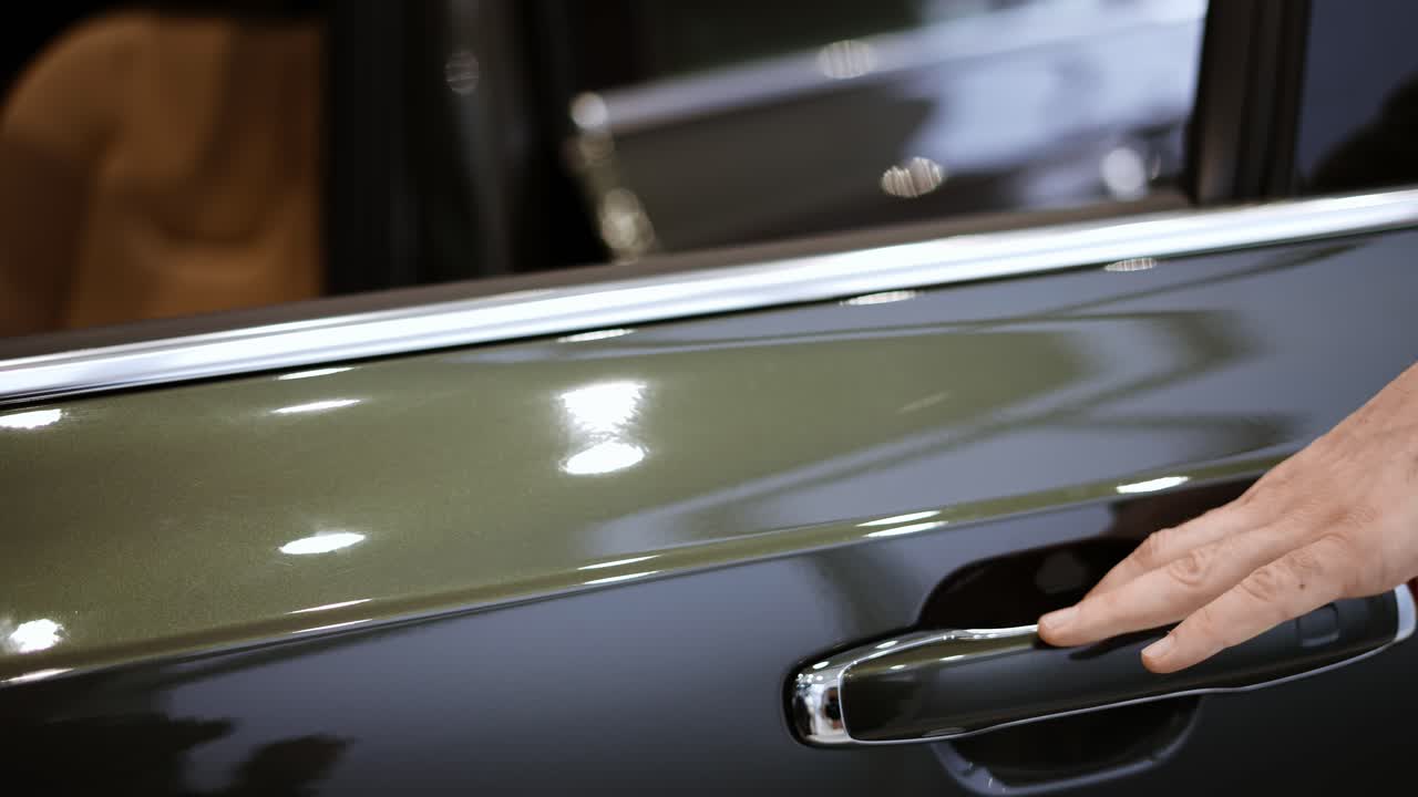 Close up of man's hand opening car door. Auto business, car sale, technology and people concept