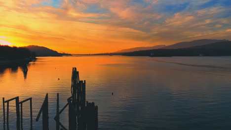 stunning sunset over calm river with mountain view