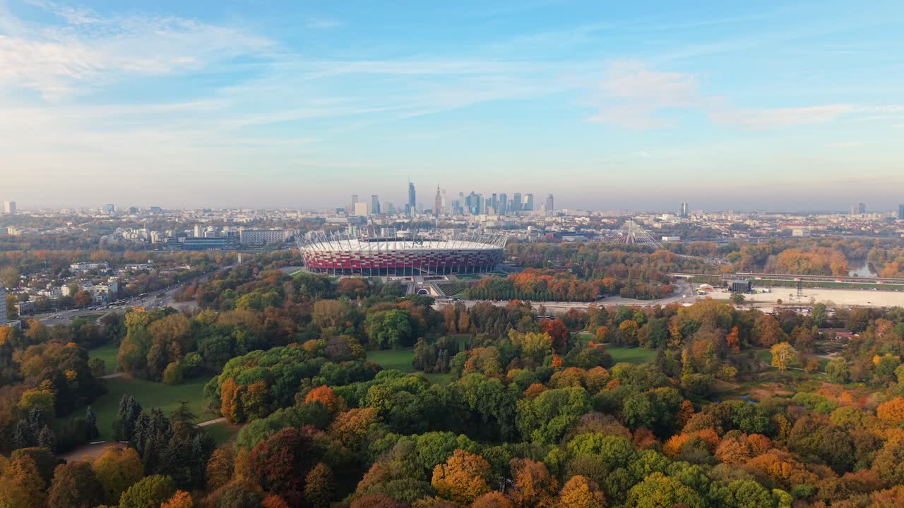 Aerial View of National Football Stadium in Warsaw Poland. Flying Above Colorful Trees on Sunny Misty Autumn Day