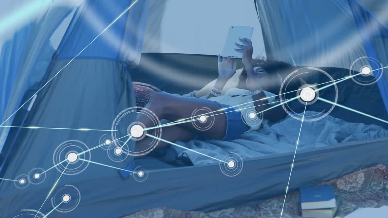 Animation of network of connections over diverse women in tent with tablet