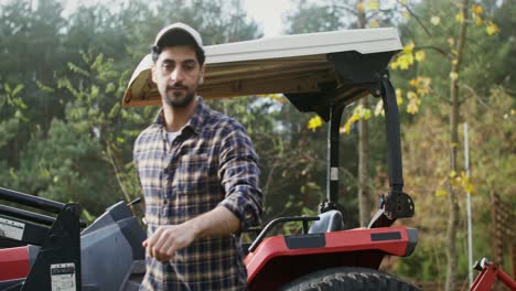 farmer walking near a tractor on a farm