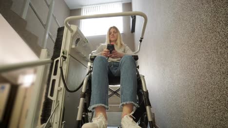 a girl in a wheelchair effortlessly ascends the stairs using a stair lift.