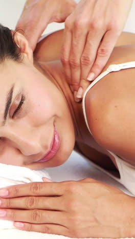 masseuse giving massage to relax woman