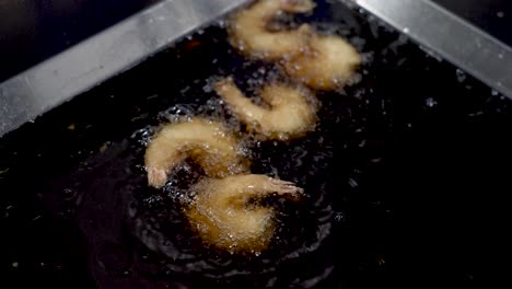 crispy delights come to life as shrimp sizzle in hot oil at a bustling seaside eatery