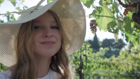 closeup of a woman with hat in a vineyard