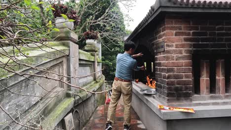 man performing joss paper burning ritual