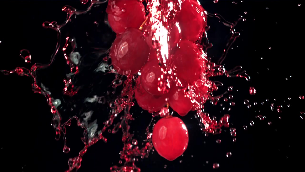 Fresh Red Grapes Splashing with Water in Slow Motion