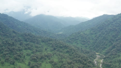 Aerial-view-of-the-green-hills-of-Tafi-del-Valle,-Argentina,-wide-backward-shot