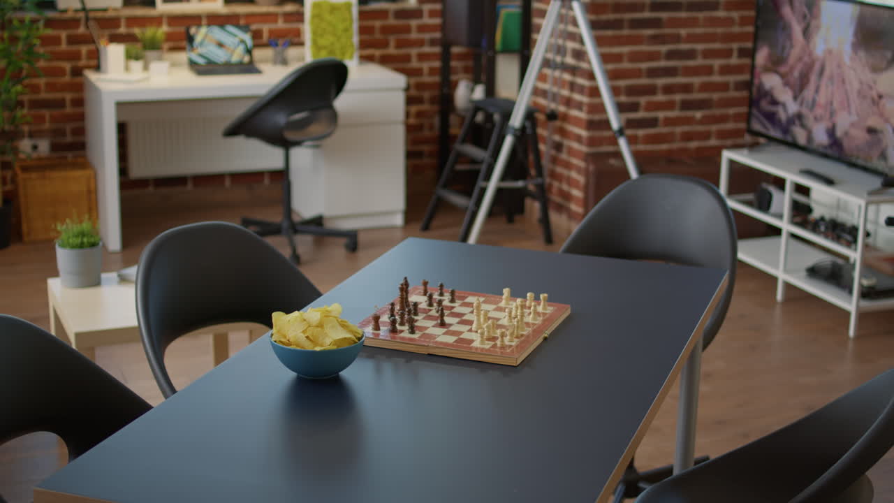 Empty living room with snacks and board games on table
