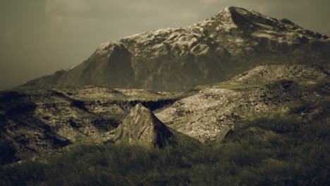 a scenic view of a mountain range with snow on the peaks